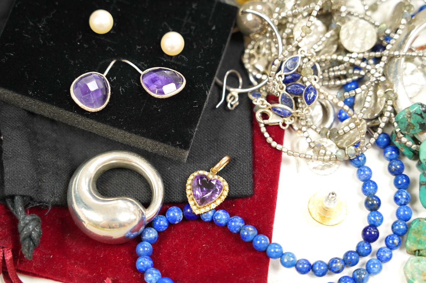 Assorted silver and costume jewellery including a Tiffany Elsa Peretti round circle pendant, 34mm, a lapis lazuli necklace and an amethyst heart pendant. Condition - fair